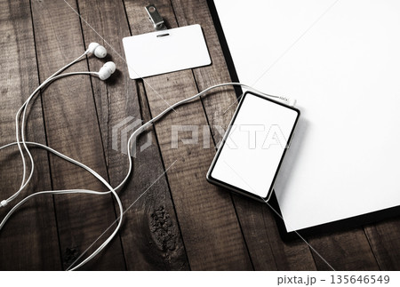 Smartphone, badge and headphones Smartphone, badge and headphones 135646549