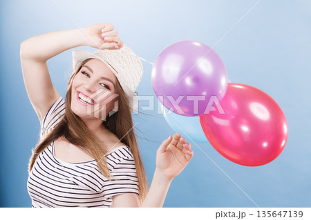 Woman summer joyful girl with colorful balloons Woman summer joyful girl with colorful balloons 135647139
