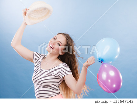 Woman summer joyful girl with colorful balloons 135647142