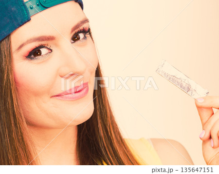Woman eating chewing gum Woman eating chewing gum 135647151