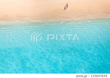 Summer aerial beach top view couple walking sandy shore calm waves landscape 135647634