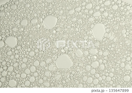 The texture of the foam of shower gel or soap suds. Macrophotography 135647899