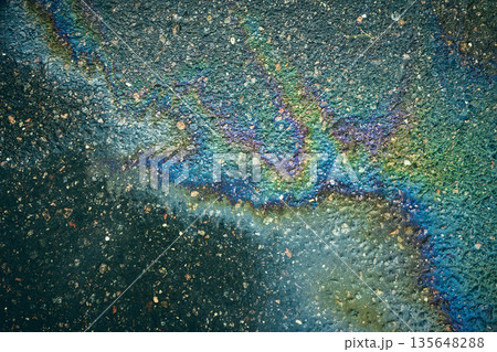 Colorful fuel spill on the pavement, offering an eye-catching abstract backdrop. Colorful fuel spill on the pavement, offering an eye-catching abstract backdrop. 135648288