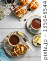 Easter food table setting. Cross Buns with butter, served with tea. Breakfast concept 135648544
