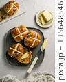 Cross Buns with butter in a plate. Breakfast concept. Top view. Easter treat buns 135648546