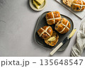 Cross Buns with butter in a plate. Breakfast concept. Top view with copy space. Easter treat buns 135648547
