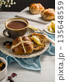 Easter food table setting. Cross Buns with butter, served with tea. Breakfast concept 135648559