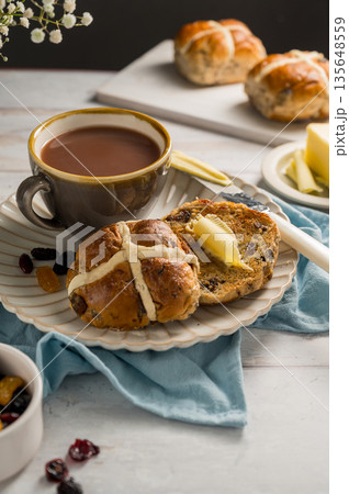 Easter food table setting. Cross Buns with butter, served with tea. Breakfast concept 135648559