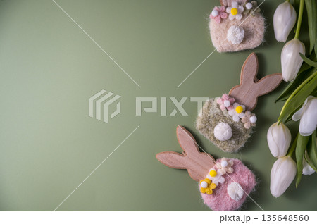 Easter spring holiday background with easter wooden bunnies and white tulip flowers, flat lay and copy space 135648560