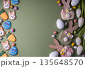 Easter spring holiday background with easter cookies: buny, carrot and egg with white tulip flowers, flat lay and copy space 135648570