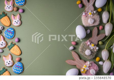 Easter spring holiday background with easter cookies: buny, carrot and egg with white tulip flowers, flat lay and copy space Easter spring holiday background with easter cookies: buny, carrot and egg with white tulip flowers, flat lay and copy space 135648570