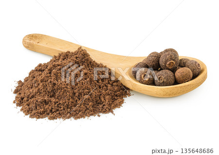Allspice pepper and ground in wooden spoon isolated on white background. Jamaica pepper, Pimenta dioica or myrtle pepper Allspice pepper and ground in wooden spoon isolated on white background. Jamaica pepper, Pimenta dioica or myrtle pepper 135648686