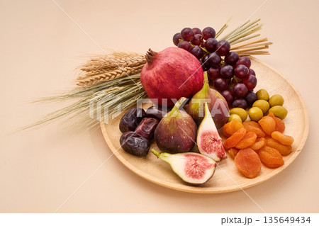 Seven species fruits and grains offering on plate 135649434
