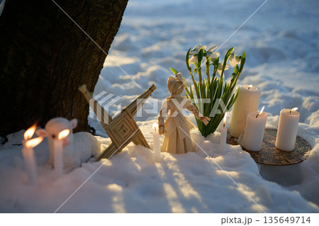 Imbolc pagan ritual with brigid's cross in snow 135649714