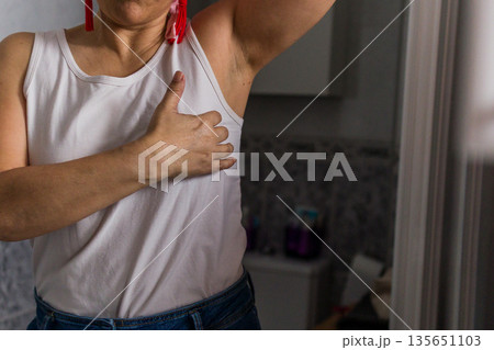 Woman hand performing breast cancer self examination Woman hand performing breast cancer self examination 135651103