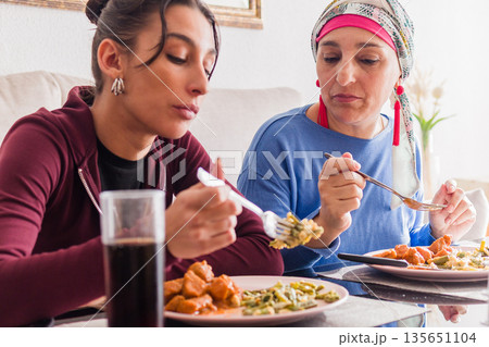 Mother and daughter sharing meal during chemotherapy recovery Mother and daughter sharing meal during chemotherapy recovery 135651104