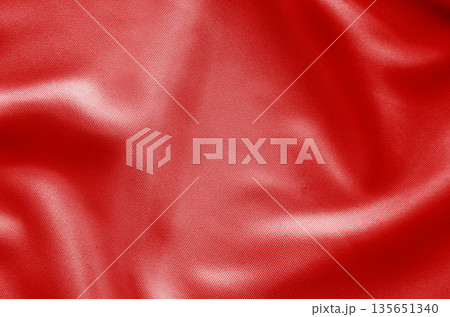 old red fabric texture with dynamic folds creating a powerful abstract background statement. old red fabric texture with dynamic folds creating a powerful abstract background statement. 135651340