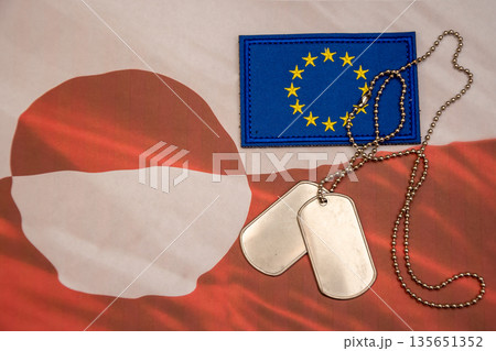 Soldier dog tags with European Union flag on Greenland national background. 135651352