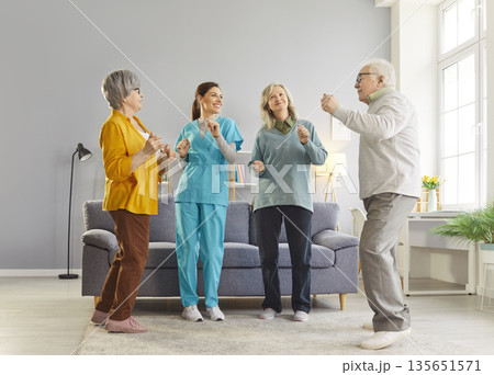 Senior people having fun with doctor, nurse amusing, psychotherapy, care assistant, retirement home 135651571