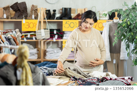 Pregnant latina looking warm beige pants 135652066