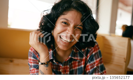 Young woman confidently smiling and enjoying moment 135652177