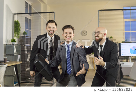 Happy businessmen team dancing in office celebrating success and teamwork energy Happy businessmen team dancing in office celebrating success and teamwork energy 135652825