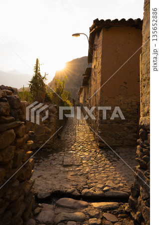 Golden sunset light on cobbled backstreet in Ollantaytambo, Peru Golden sunset light on cobbled backstreet in Ollantaytambo, Peru 135652886