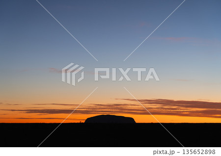 Iconic Uluru silhouette against horizontal sunrise sky, Australia 135652898