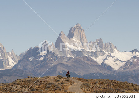 Cyclist bikepacking in front of massive Mount Fitz Roy, Patagonia, Argentina Cyclist bikepacking in front of massive Mount Fitz Roy, Patagonia, Argentina 135652931