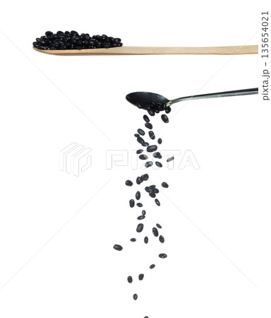 Black Bean fall, black grain beans explode abstract cloud fly from silver spoon. Beautiful complete seed pea bean, food object design. Selective focus freeze shot white background isolated Black Bean fall, black grain beans explode abstract cloud fly from silver spoon. Beautiful complete seed pea bean, food object design. Selective focus freeze shot white background isolated 135654021
