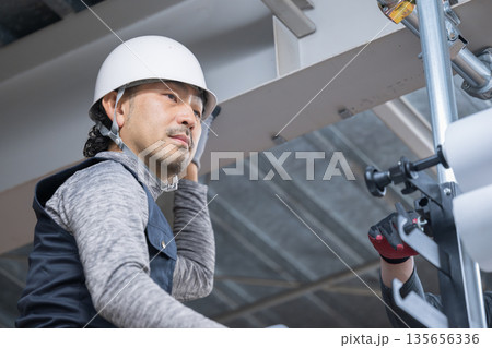 天井が近い高所の足場施工作業　鳶職や作業員のイメージ　	 135656336
