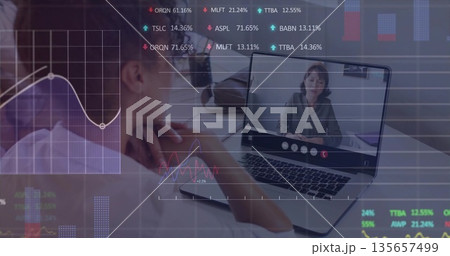 Asian woman reviewing charts in office on laptop call with colleague in business blouse Asian woman reviewing charts in office on laptop call with colleague in business blouse 135657499