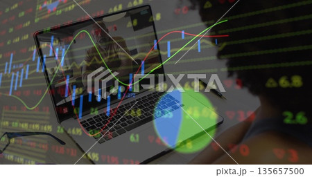 Business woman in sleeveless top analyzing chart overlay on laptop at home desk, copy space 135657500