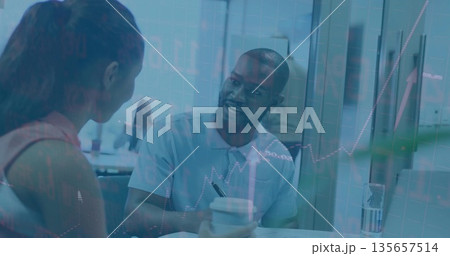 Office colleagues meeting at table writing notes, holding coffee and straw cups with rising graph Office colleagues meeting at table writing notes, holding coffee and straw cups with rising graph 135657514