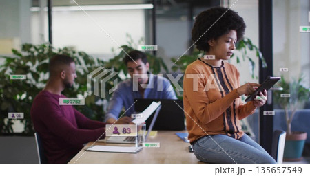 Colleagues in business attire collaborating at office table, with devices and documents, copy space Colleagues in business attire collaborating at office table, with devices and documents, copy space 135657549