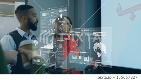 Colleagues analyzing floating data panels in office, with tablet coffee cup red arrow projection 135657827