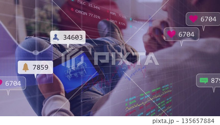Professional analyzing 3D model on tablet in office, with floating notifications and stock charts Professional analyzing 3D model on tablet in office, with floating notifications and stock charts 135657884