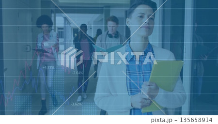 Leading educator walking in school hallway, with yellow folder and translucent line graph overlay 135658914