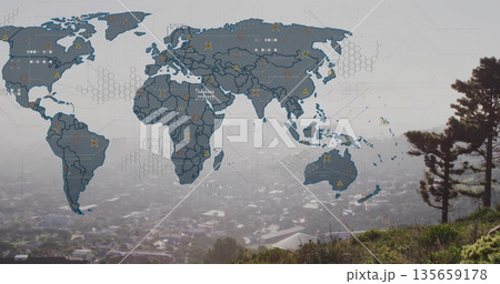 Displaying digital world map overlay floating on grassy hillside, with hex grid and icon markers 135659178