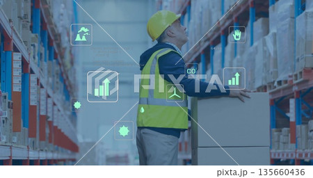 Warehouse worker wearing helmet hi-vis vest placing box in warehouse with digital icons, copy space Warehouse worker wearing helmet hi-vis vest placing box in warehouse with digital icons, copy space 135660436