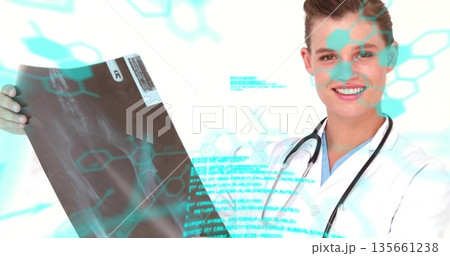 Examining radiograph, doctor in lab coat at clinic with stethoscope and molecular code overlays Examining radiograph, doctor in lab coat at clinic with stethoscope and molecular code overlays 135661238