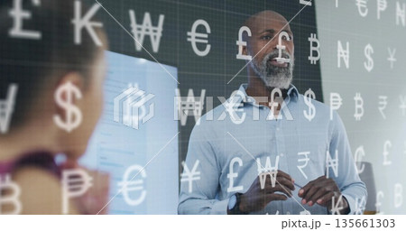 Gesturing presenter in blue shirt pointing at display screen in meeting room, with currency symbols Gesturing presenter in blue shirt pointing at display screen in meeting room, with currency symbols 135661303