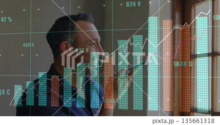 Speaking male professional holding smartphone near mouth at wooden window, with data charts overlay 135661318