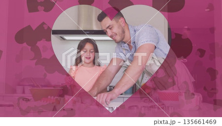 Father wearing striped apron and daughter mixing dough in kitchen, with rolling pin, pink heart Father wearing striped apron and daughter mixing dough in kitchen, with rolling pin, pink heart 135661469