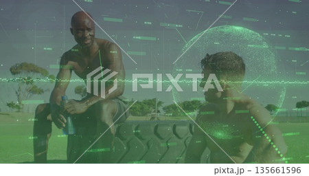 Resting shirtless male athletes wearing shorts on sports field, with tire water bottle overlay Resting shirtless male athletes wearing shorts on sports field, with tire water bottle overlay 135661596