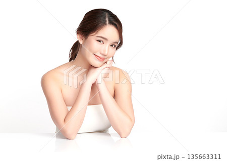A beautiful young Asian woman with clean, fresh skin against a white background. Skincare, facial treatment, cosmetology, beauty, and spa. An elegant portrait of an Asian woman. A beautiful young Asian woman with clean, fresh skin against a white background. Skincare, facial treatment, cosmetology, beauty, and spa. An elegant portrait of an Asian woman. 135663311