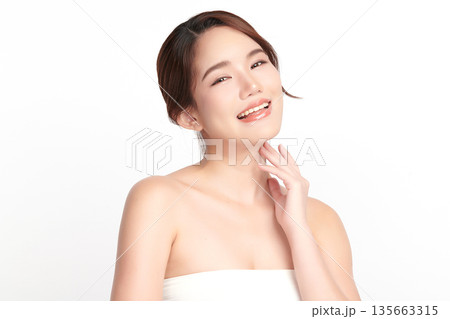 A beautiful young Asian woman with clean, fresh skin against a white background. Skincare, facial treatment, cosmetology, beauty, and spa. An elegant portrait of an Asian woman. A beautiful young Asian woman with clean, fresh skin against a white background. Skincare, facial treatment, cosmetology, beauty, and spa. An elegant portrait of an Asian woman. 135663315