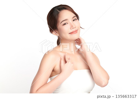 A beautiful young Asian woman with clean, fresh skin against a white background. Skincare, facial treatment, cosmetology, beauty, and spa. An elegant portrait of an Asian woman. A beautiful young Asian woman with clean, fresh skin against a white background. Skincare, facial treatment, cosmetology, beauty, and spa. An elegant portrait of an Asian woman. 135663317