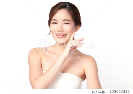 A beautiful young Asian woman with clean, fresh skin against a white background. Skincare, facial treatment, cosmetology, beauty, and spa. An elegant portrait of an Asian woman. A beautiful young Asian woman with clean, fresh skin against a white background. Skincare, facial treatment, cosmetology, beauty, and spa. An elegant portrait of an Asian woman. 135663322