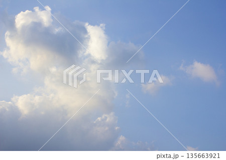 It's a blue sky with atmospheric puffy clouds. 135663921